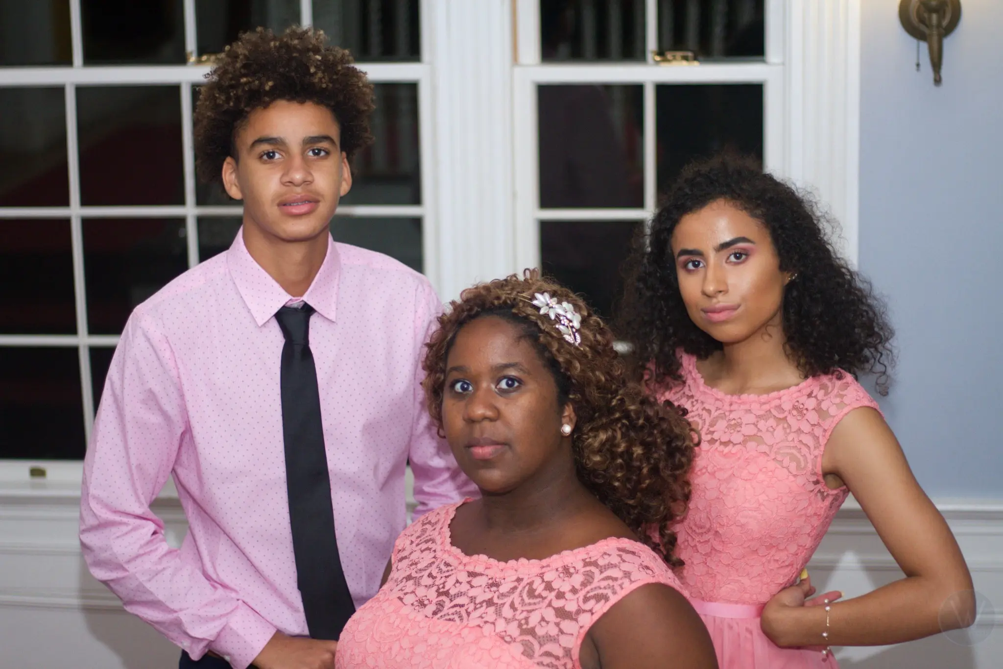 Three wedding guests dressed in coordinated pink